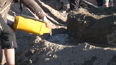 while-builder-working-they-pouring-water-to-mix-cement-old-fashion