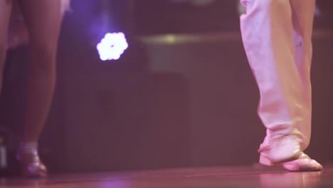 close-up-of-couple-of-dancer's-dancing-at-a-show-with-white-costumes-and-shiny-shoes-,-lifestyle-cuban-salsa-dance
