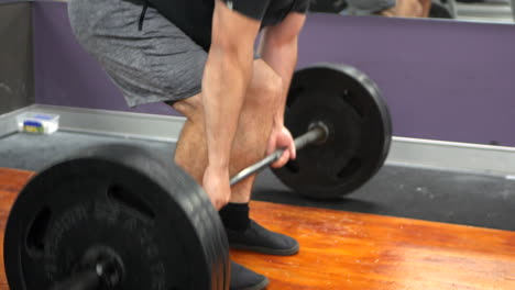 Male-performs-a-set-of-deadlift-exercises-at-a-gym