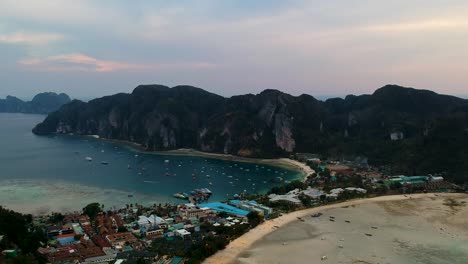 Aerial-view-of-beach-towns-at-sunset-from-Koh-Phi-Phi-island-viewpoint,-Thailand