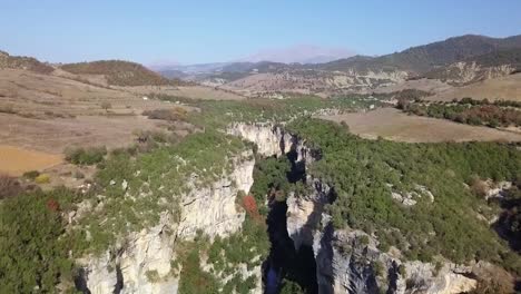 Rising-above-looking-it-Osumi-Canyon-with-bright-blue-skies-travelling-around-Albania-on-a-road-trip-in-Europe