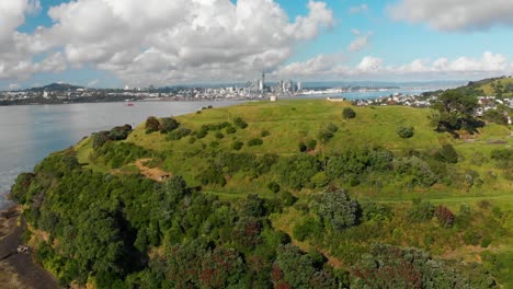 Aerial-shot-of-North-Head-with-Auckland-skyline-in-background,-New-Zealand