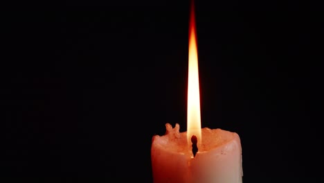 The-showcases-of-colorful-single-candlelight-on-black-background-with-the-effect-of-light-and-slow-motion