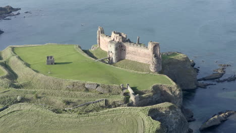 An-aerial-view-of-the-front-of-Tantallon-Castle-ruin-on-a-sunny-day,-East-Lothian,-Scotland