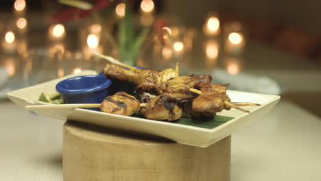 Chicken-Barbeque-On-Stick-With-Candle-Light-In-The-Background-4K