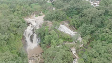 AERIAL---Waterfalls,-cascades-at-Jos-Plateau,-Nigeria,-reverse-rising-reveal-shot