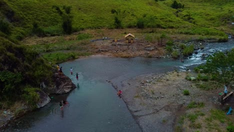 Drone-shot-of-people-jumping-in-a-river