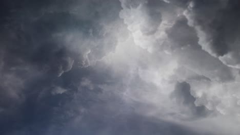 POV-lightning-flashes-in-dark-cumulonimbus-clouds,-thunderstorm-4K