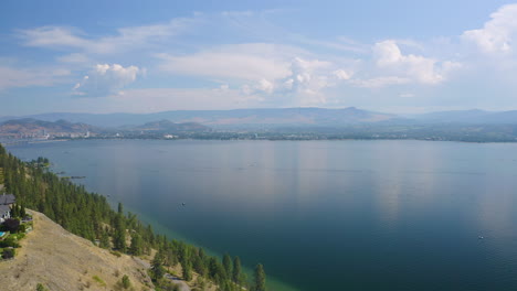 Aerial-view-across-the-Okanagan-Lake-from-West-Kelowna-on-a-beautiful,-cloudy-day