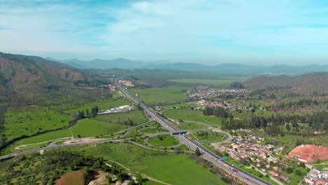 Aerial-view-dolly-in-of-a-traffic-circle-on-route-68-Santiago-Valparaíso,-a-major-connection-between-Chile's-main-cities
