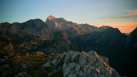 Forward-movement-over-a-rock-with-a-camera-on-a-gimbal-filmed-in-4k-revealing-beautiful-mountains-at-sunrise-in-the-Slovenian-mountains-in-the-alps,-with-beautiful-clear-skies
