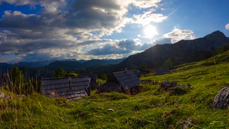 Timelapse-up-in-a-mountain-village-off-wooden-houses-and-clouds-passing-by