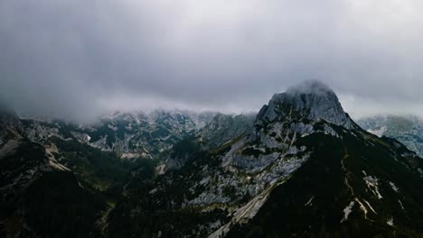 Drone-hyper-lapse-of-beautiful-mountains-covered-in-clouds-up-in-the-Slovenian-mountains-in-the-alps-with-left-to-right-drone-movement-and-clouds-moving