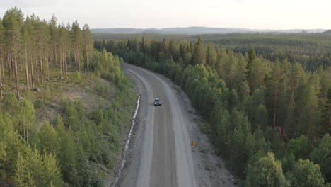 4k-Drone-shot-of-a-car-driving-in-the-wild-forest