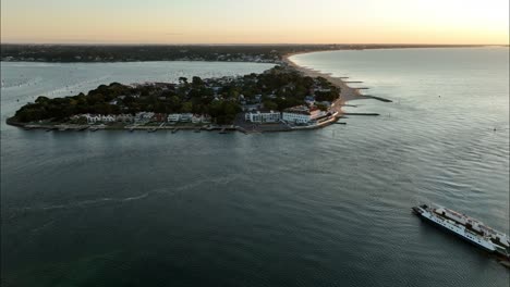 Aerial-view-of-the-entrance-to-Poole-harbour,-Sandbanks-ferry-at-sunrise,-Dorset,-UK