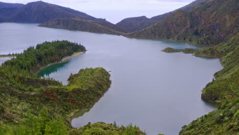 Woody-shoreline-of-Lagoa-do-Fogo-crater-lake-in-Azores,-aerial-view
