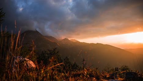Time-lapse-of-mountains-covered-in-the-clouds-at-sunrise-in-the-morning-with-beautiful-colors-in-the-sky-and-the-sun-going-up