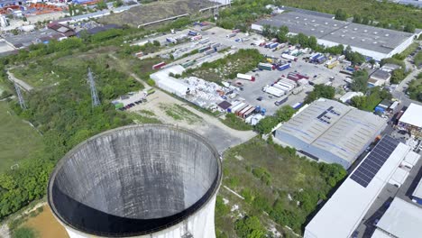 Aerial-arc-around-natural-draft-cooling-tower,-Heidelberg-Cement-Plant