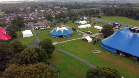 Slow-Aerial-Exploration-Shot-Heading-Towards-A-Round-Blue-Tent-Where-Artists-Will-Be-Performing