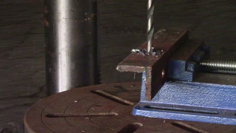 Slow-Motion---Drill-press-making-steel-shavings-as-it-cuts-through-a-section-of-steel-angle-iron