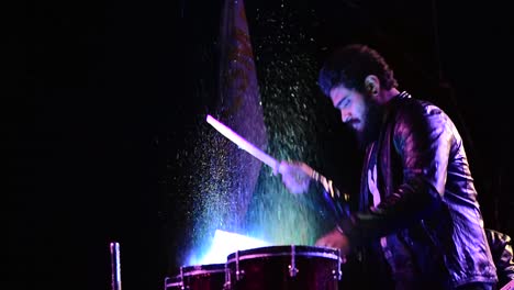 Drummer-playing-drums-after-putting-water-on-them-during-an-architectural-college-fest-in-Kerala