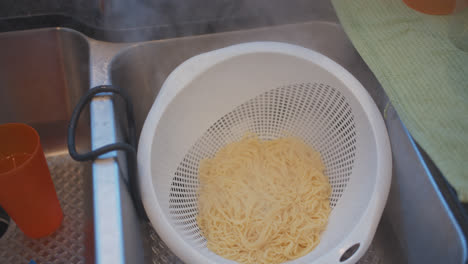 Straining-spaghetti-in-a-sink