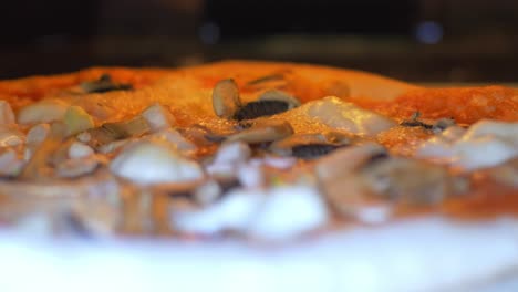 Pizza-cooking-in-very-hot-oven,-close-up-cheese-bubbles-2