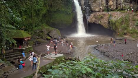 Tegenungan-Waterfall,-full-of-tourists-taking-pictures,-the-real-view-of-a-bali-holiday,-vacation-reality