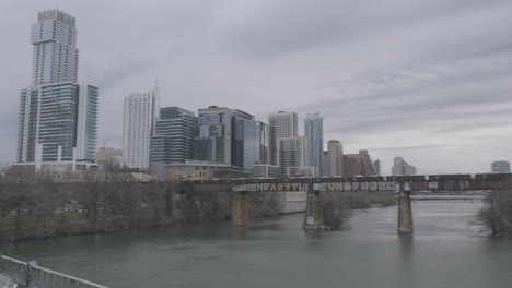 a-freight-train-crosses-the-Colorardo-River-and-heads-into-downtown-Austin