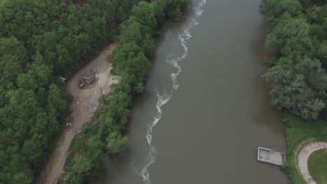 Drone-flies-over-a-river-in-the-Midwestern-USA-and-pans-up-to-eventually-reveal-a-quarry