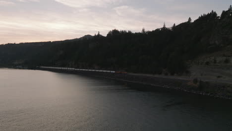 Drone-aerial-of-a-train-traveling-along-the-Columbia-River-in-southern-Washington-1