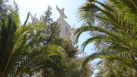 Cristo-Rei-Monument-between-the-Palms-under-a-Blue-Sky-in-Portugal