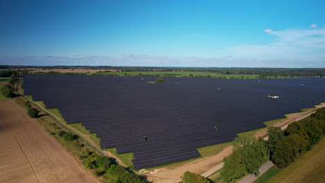 Aerial-view-flying-towards-the-corner-of-huge-solar-panel-array-generating-renewable-energy