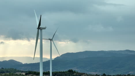 Close-up-view-of-stopped-wind-turbine-in-Coll-de-Moro-wind-mill-park-on-cloudy-day-at-sunset,-Spain