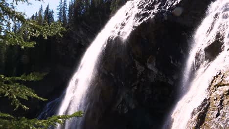 Tilt-down-of-cascading-waterfall-in-summer