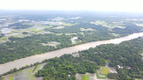 Aerial-landscape-of-overflown-flooded-river-with-agriculture-land-and-village-countryside