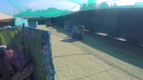 Girls-and-boys-playing-paintball-in-an-outdoor-arena