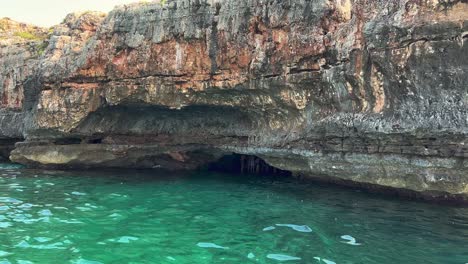 Grotta-del-Presepe-or-Nativity-Scene-Grotto-along-Ionian-coast-of-Salento-in-Apulia-with-emerald-colored-water,-Italy