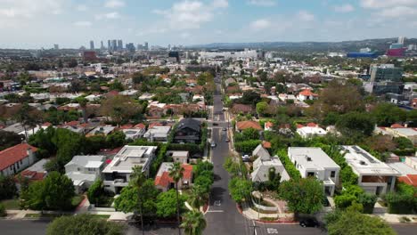 West-Hollywood-suburb-with-the-Los-Angeles-skyline-in-the-distance---aerial-daytime-flyover