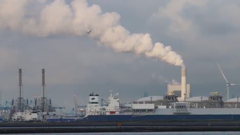 Commercial-docks-with-chimney-emitting-steam-or-smoke