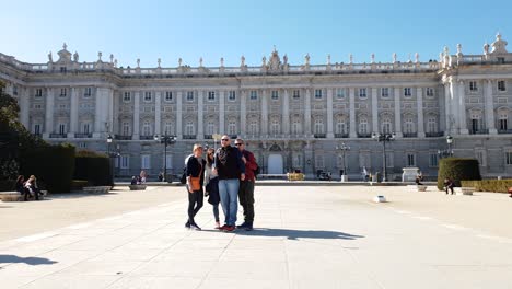 Tourists-taking-a-selfie-in-front-of-Palacio-Real,-The-Royal-Palace,-in-Madrid,-Spain