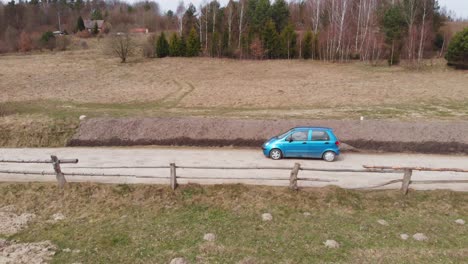 Two-blue-cars-passing-each-other-on-a-country-road