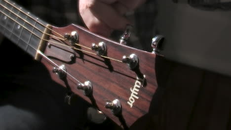 man-tunes-an-old-guitar