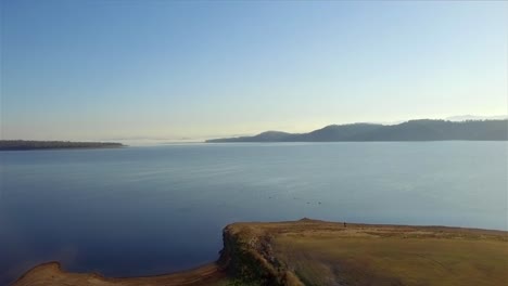 Rising-aerial-shot-of-Lake-Wivenhoe-on-a-beautiful,-clear-winter's-morning-in-Queensland,-Australia