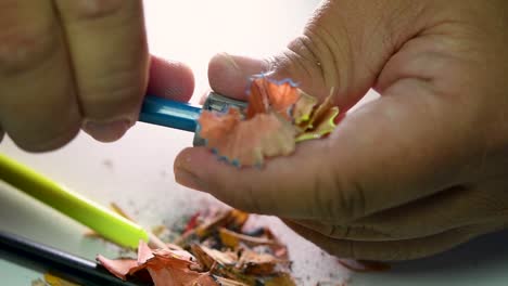Footage-of-hands-slowly-sharpening-a-pencil-and-some-coloured-pencils-with-a-Wedge-Pencil-Sharpener