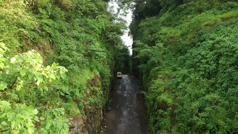 Road-trip-on-Indian-road-in-Monsoon---Rainy-season-seen-here-at-Dudhiware-Khind-at-Lonavala,-India---most-selling-stock-aerial-drone-footage