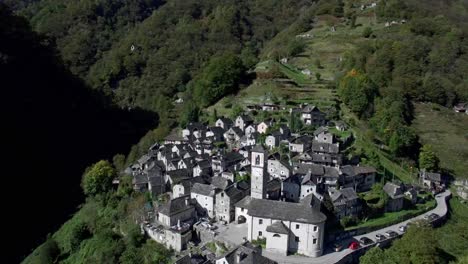 aerial-view-of-medieval-town-village-of-Corippo-in-the-mountains,-small-mountain-village-in-Ticino-Corippo,-Verzasca-valley,-Switzerland