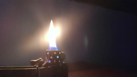 Lighter-Flame-at-night-on-a-table