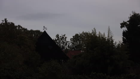 Time-lapse-of-barn-house-with-weather-vane-on-overcast-day