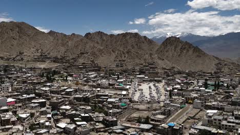 the-leh-city-with-house-made-of-mud-and-local-materials-crowded-the-Buddhist-flag-fluttering-due-to-winds-view-from-leh-palace